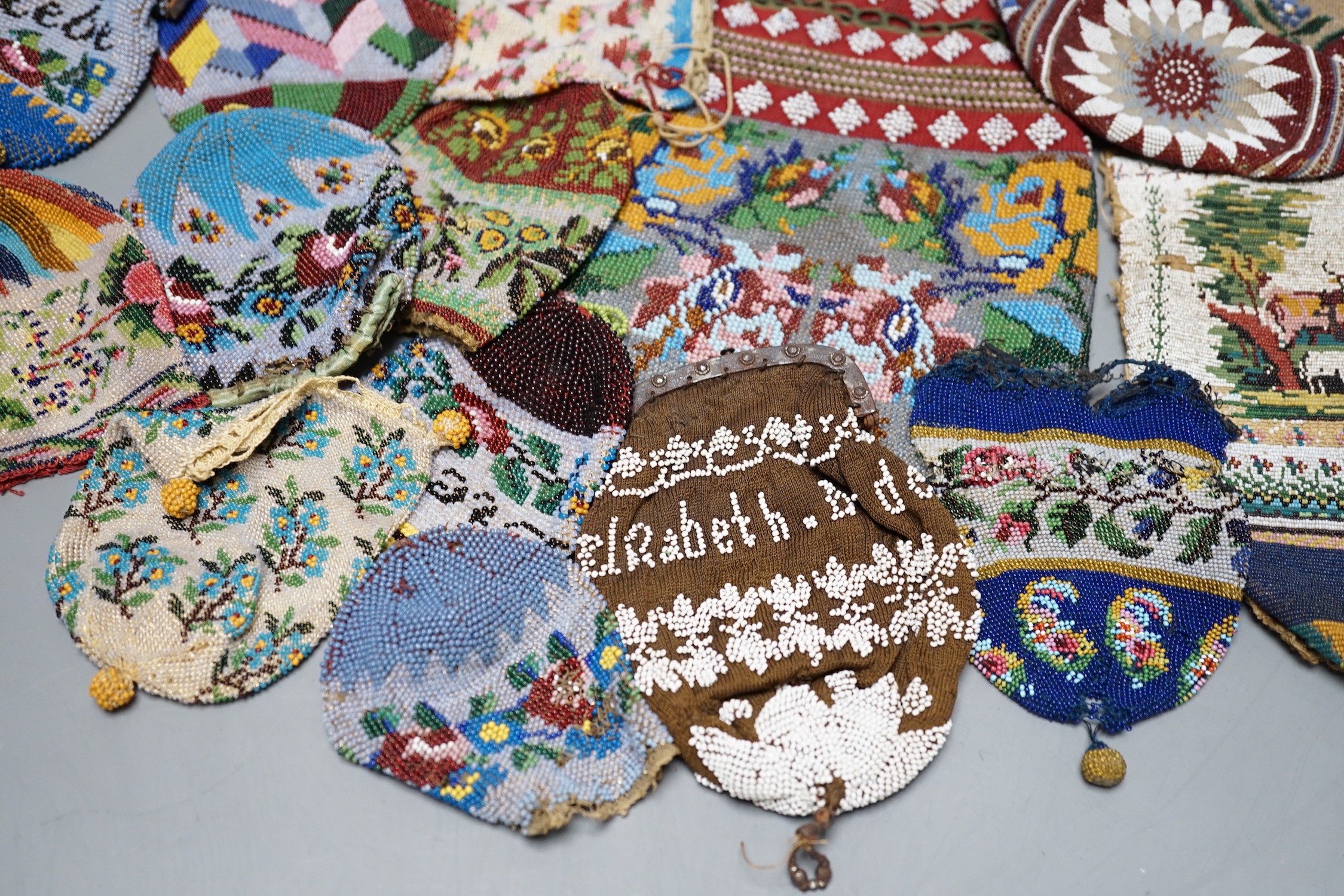 Three Victorian beadwork bags, circa 1860, largest 17cm high, and a collection of eleven smaller reticules and purses